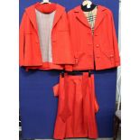 A Grossfell red mac by Grenfell three quarters - a green velvet jacket and skirt by John Comery -