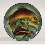 A Moorcroft plate depicting a trout, with initials SB to reverse, diameter approx 25.