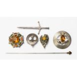 A collection of Scottish silver brooches, two set with citrines, a dagger,