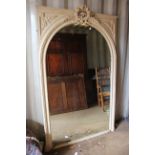 A 19th Century white painted overmantle mirror, the glass panel of arched form,