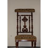 A Victorian walnut bobbin turned prie-dieu chair, upholstered back rest,