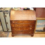 A George III oak bureau, the fall front with a fitted interior, four drawers below,