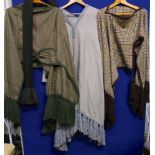 A selection of capes to include a check cape with brown wool tassels,