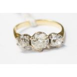 A diamond and yellow metal ring, set with three claw set old cut diamonds,