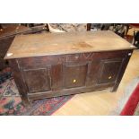 An early 18th Century oak coffer, having a three panelled front, with raised and fielded panels,