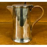 A silver plate coffee pot with wicker handle John Grinsell and Sons