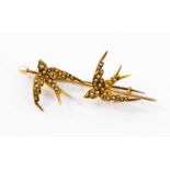 A yellow metal ladies bar brooch (probably 14ct) with two 'swallows in flight'' both set with seed