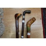 A collection of three walking sticks to include one with an owl handle,