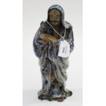 Late 19th century earthenware Chinese figure of a cloaked man carrying slippers