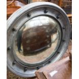 A large convex mirror with silver painted frame,