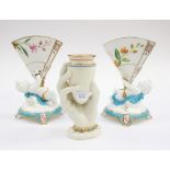 Royal Worcester hand and beaker vase and a pair of putti and jem vases,