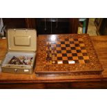 A late 19th Century rosewood and satinwood chessboard with inlaid parquetry border;