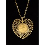 An Edward VII 1909 gold Half Sovereign pendant, fitted in a 9ct gold heart shaped open work mount,