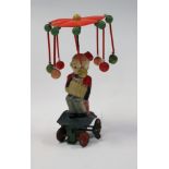 A Japanese clockwork toy of a seated accordion player, with key,