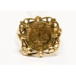 A 9ct gold ring set with coin type medallion, 3.