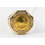 A 9ct ring, set with a Krugerrand, weighing approx 8.