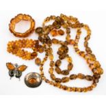 A Continental sterling silver oval brooch set amber, two amber bracelets,