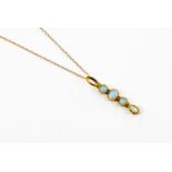 An opal and 18ct gold drop pendant, comprising four opals two round, one oval and a tear drop,