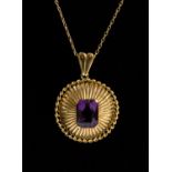 A yellow metal (tests as 18ct gold) pendant in the form of a domed circle with rope edge,