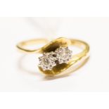 A diamond and 18ct gold ring two stone, witha cross over design, size L,