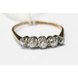 A diamond, yellow metal, probably 9ct gold, with five graduated claw set old cut diamonds,