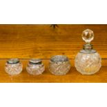 A late 19th Century glass and silver mounted dressing table set including scent bottle and three