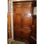 A George III oak standing corner cupboard,