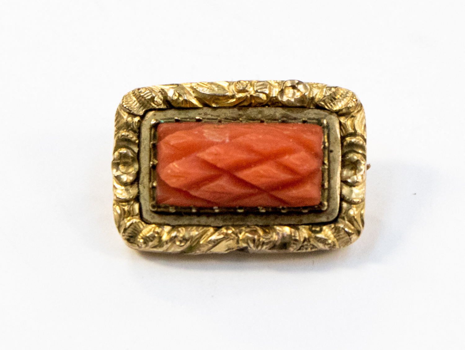 A carved coral brooch,