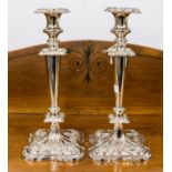 A pair of weighted plated candelabrum,