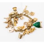 A 9ct gold charm bracelet, with various charms such as a jade Buddha, a ballerina,