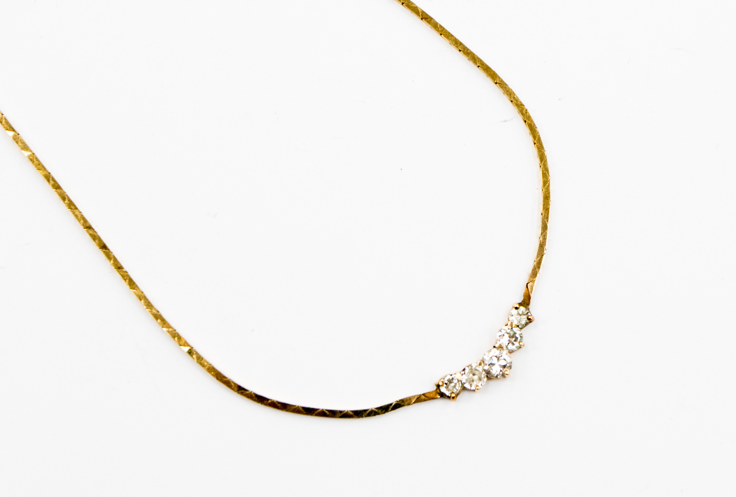A 9ct gold and diamond necklace, comprising five graduated diamonds set to the front of the necklet,