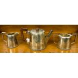 A silver Walker and Hall three part tea service, Sheffield, the teapot inscribed and dated 1942,