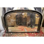 An ebonised over mantle mirror,