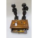 A Victorian, oak desk stand, together with a pair of carved figures of young boys playing,