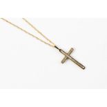 A diamond 9ct gold cross, channel set with brilliant cut diamonds approx size,