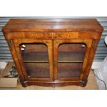 A mid Victorian walnut and marquetry inlaid side cabinet, fitted with two glazed doors,