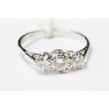 A diamond and 18ct white gold ring set with three claw set diamonds,