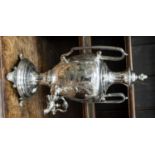 A Victorian EPNS engraved large tea urn, on circular base with four scroll feet,