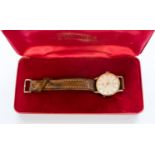 A boxed circa 1960s 9ct gold gents Smiths wristwatch on a tan leather strap