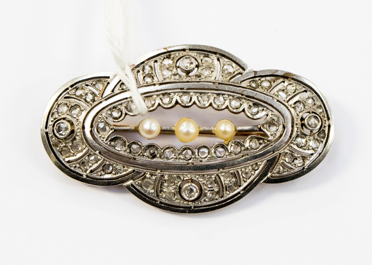 An Art Deco diamond and pearl brooch, in white and yellow metal,