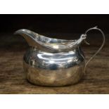 A silver cream jug, Birmingham 1915, T.H. Hazelwood and Co, approx 2.