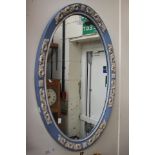 An oval mirror in Wedgwood jasper ware design,