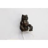 A Japanese dark wood carved Netsuke, depicting an Owl sitting on a gnarled branch,