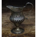 A Georgian silver cream jug, monogrammed London, 1784, approx height 10cm, engraving reads I.M.