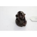 A Japanese dark wood carved Netsuke, depicting a Monkey sitting on the back of a Tortoise,