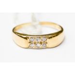 An 18ct gold ring pave set with six small diamonds, approx 0.