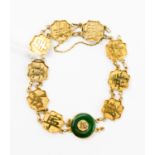 Chinese 18ct gold 'Good Luck' character bracelet, with a donut jadeite ring detail to the centre,