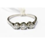 Three stone diamond ring, stamped Platinum, with graduated claw set diamonds, finger size N,