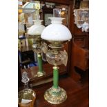 An oil lamp complete, brass decorative base, green column, cut glass bowl and opaque glass shade,