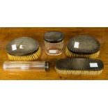 A George V silver toilet set including glass jars and silver backed brushes, Adie Bros,